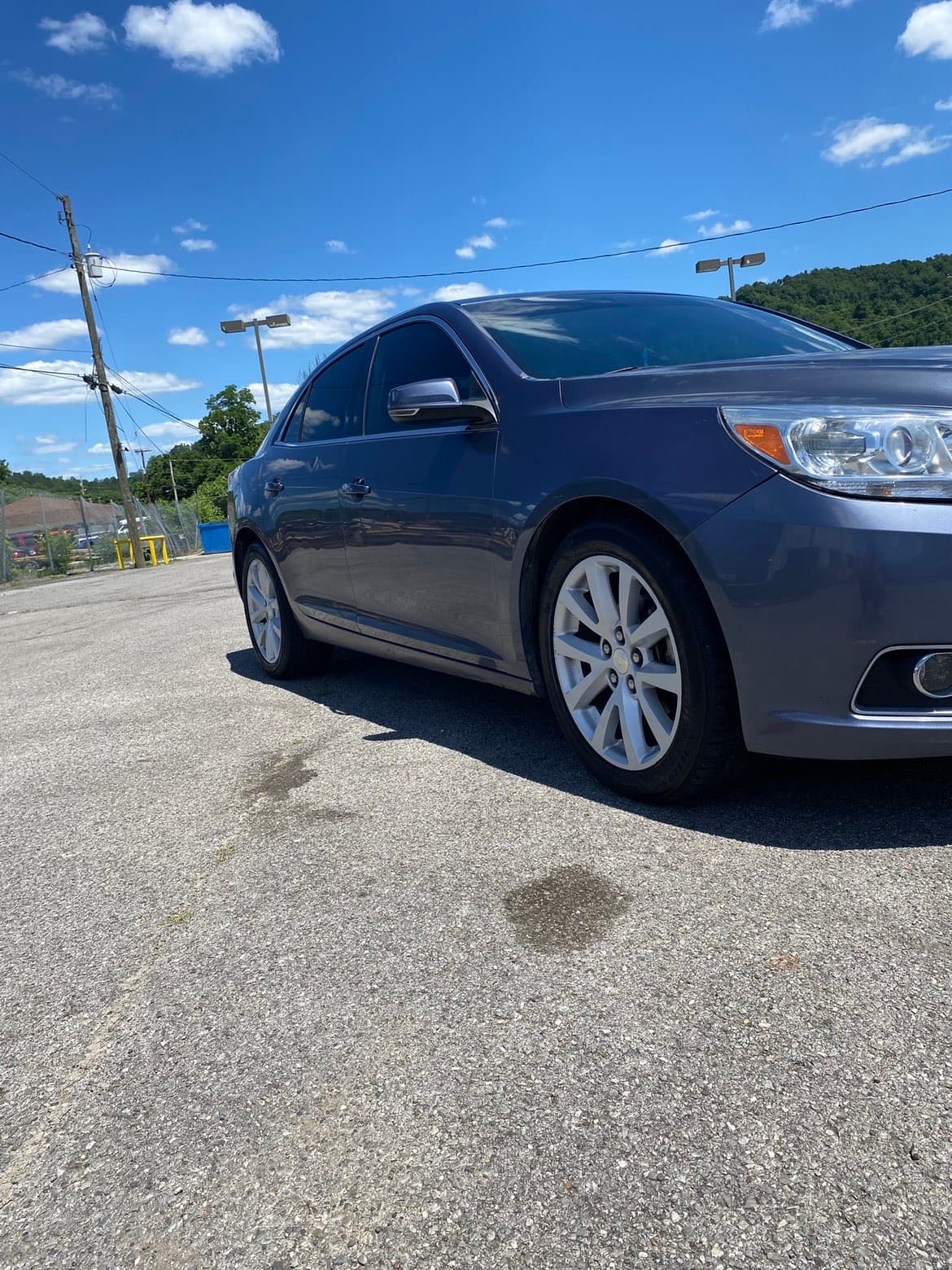 Clean glossy paint finish on grey Chevrolet Malibu side view
