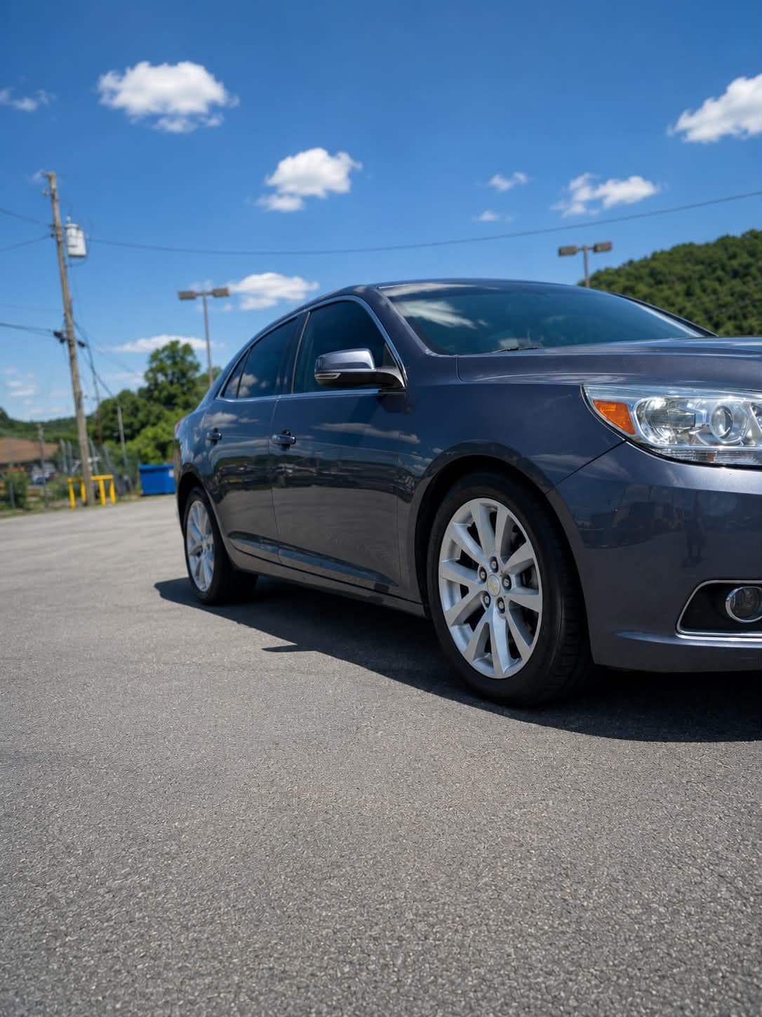 Detailed front bumper and grille of a grey Chevrolet Malibu